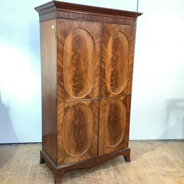 A George III and later mahogany cupboard, composed of period elements, the ovolo and cavetto moulded