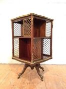 A late 19th century gilt-brass mounted walnut revolving bookcase in the French taste, of