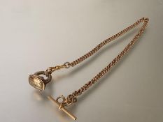 A 9ct gold Albert curblink watch chain, with t-bar and lobster clasp, suspending a yellow metal