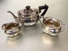 A late Victorian silver three piece bachelor's tea service, Thomas Hayes, Birmingham 1897, in the