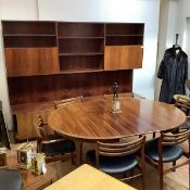 A 1960's Danish rosewood circular extending dining table, raised on shaped square tapered