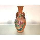 A Chinese famille rose porcelain twin-handled vase, 19th century, of baluster form, with