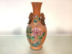 A Chinese famille rose porcelain twin-handled vase, 19th century, of baluster form, with
