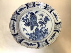 An 18th century blue and white Delft charger, probably Dutch, unusually decorated with a bird