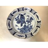 An 18th century blue and white Delft charger, probably Dutch, unusually decorated with a bird