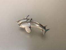 Georg Jensen, a Danish sterling silver brooch, modelled as two dolphins, design no. 317. Length