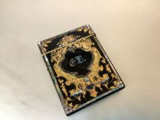 A 19th century gilt-painted and inlaid papier mache card case, decorated to one side with a