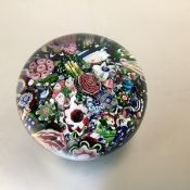 A French 19th century scrambled millefiori glass paperweight, probably Clichy, the canes