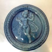 A Dunmore pottery roundel, 19th century, the turquoise-glazed plaque modelled in relief with a putto