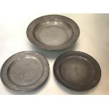 A pair of George III Scottish pewter plates, believed to be Edinburgh, together with a large shallow