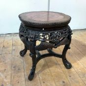 A Chinese rosewood jardiniere stand, early 20th century, the top of lobed circular outline, inset