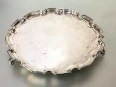 A George V silver salver in 18th century style, Adie Brothers, Birmingham 1930, circular, with pie-