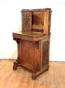 A Victorian figured walnut Davenport, the superstructure with pierced fret-carved gallery, and a