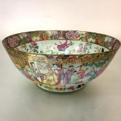 A large Canton famille rose porcelain punch bowl, 19th century, the well painted with ladies and