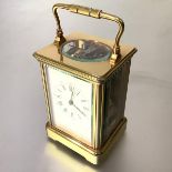 A French brass-cased carriage clock, c. 1900, the case with plain plinth base and shaped handle,