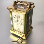 A late 19th century brass-cased alarm carriage clock, the cream enamel dial with Arabic numerals and