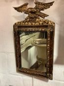A parcel-gilt carved wooden mirror in the Federal taste, the rectangular plate within a conforming