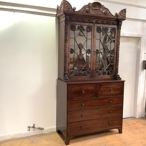 A mahogany secretaire bookcase, early 19th century, the top in the manner of William Trotter,