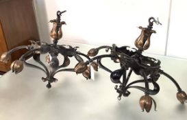 A pair of Arts & Crafts wrought-iron and copper ceiling lights, c. 1900, each with iron frame, the