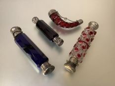 A group of 19th century white metal mounted coloured glass scent bottles comprising: a ruby glass