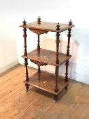 A Victorian figured walnut three-tier whatnot, each shelf with floral boxwood inlay to the centre,