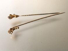 Two single stone diamond stick pins, c. 1900, each mounted in yellow metal (unmarked) as a claw