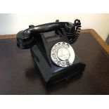 A vintage bakelite cased GPO telephone, the register inscribed Baillieston (h.15cm)