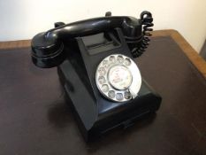 A vintage bakelite cased GPO telephone, the register inscribed Baillieston (h.15cm)