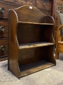 A small stained pine three tier open waterfall bookcase, dating from the first half of the 20thc.,