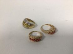 A group of three rings, two marked 14k, one marked 9k, one set two rows of yellow stones flanked