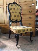 A Louis XV style ebonised side chair with upholstered back and seat, with flag decoration, on