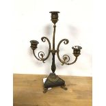 A cast metal parcel gilt two branch candelabra, on tripod base with paw feet (40cm)