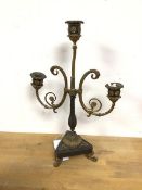 A cast metal parcel gilt two branch candelabra, on tripod base with paw feet (40cm)