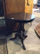 A 20thc Georgian style mahogany tripod table, the circular moulded top above baluster turned and