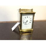 An early 20thc brass and four glass alarm carriage clock, the white enamelled dial with roman