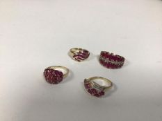 A group of four dress rings, of various styles with garnets and two with diamond chips (combined: