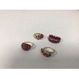 A group of four dress rings, of various styles with garnets and two with diamond chips (combined: