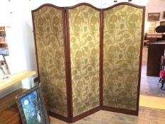 A large Edwardian three fold screen, each panel with arched top and foliate pattern fabric to either