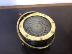 A late 19thc/early 20thc brass cased liquid filled ship's compass, with a gimble mounting (d.16cm)