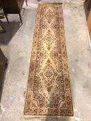 A Persian design runner with three medallions with multiple flowerhead border (354cm x 83cm)