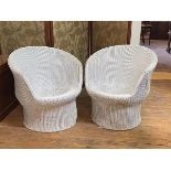 A pair of 20th century white painted wicker verandah tub shaped chairs of cylindrical form