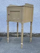 An early 20thc painted bedside table of Regency design, the square moulded top with three quarter