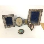A collection of photograph frames including a circular Birmingham silver frame (6.5cm), two rococo