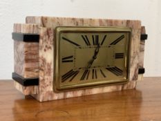 An Art Deco period rouge marble mantel clock, the dial with Roman chapter ring, eight day drum
