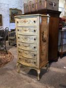 A mid 20thc cream, green and floral painted tallboy chest, of serpentine outline, fitted six drawers