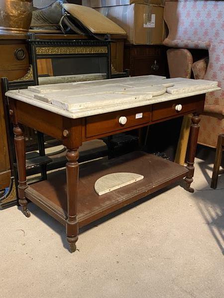 A Victorian marble topped wash stand, the raised back over a moulded top, fitted two drawers, raised