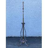 An Edwardian cast brass and wrought iron telescopic floor lamp, the ratcheted rise and fall stem