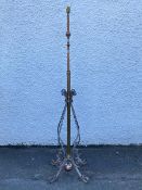 An Edwardian cast brass and wrought iron telescopic floor lamp, the ratcheted rise and fall stem