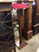 An early 20thc stained hardwood lectern, the baize lined top raised on a moulded square section