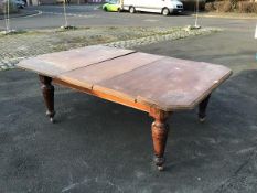 A late Victorian oak dining table, the telescopic top with multiple leaves, moulded edge and